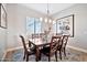 Sunlit dining area features a dark wood table and chairs with bright decor at 711 W Paso Nuevo Dr, Phoenix, AZ 85086