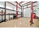 Organized garage interior featuring car lift, tool storage, and work area, suitable for various projects and maintenance at 711 W Paso Nuevo Dr, Phoenix, AZ 85086