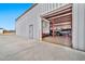 Exterior side view of metal garage with car lift inside, offering secure vehicle storage and maintenance space at 711 W Paso Nuevo Dr, Phoenix, AZ 85086