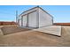 A large detached garage with a white exterior and two bays sits on a large lot with a block wall at 711 W Paso Nuevo Dr, Phoenix, AZ 85086