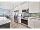 Bright kitchen features stainless steel appliances and white cabinets at 711 W Paso Nuevo Dr, Phoenix, AZ 85086