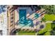 Aerial view of a community pool with mature trees and lounge chairs at 7110 E Continental Dr # 1031, Scottsdale, AZ 85257