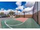 Outdoor basketball court showcasing green and red surfacing, enclosed by a secure, tall chain-link fence at 7110 E Continental Dr # 1031, Scottsdale, AZ 85257