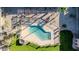 Overhead shot of sparkling blue community pool, lounge area, grilling station, and well-manicured landscaping at 7110 E Continental Dr # 1031, Scottsdale, AZ 85257