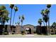 Charming apartment complex featuring desert landscaping with palm trees against a backdrop of clear blue skies at 7110 E Continental Dr # 1031, Scottsdale, AZ 85257