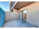 Outdoor patio with patterned pavers, stucco walls, a sliding glass door, and an upper deck at 7110 E Continental Dr # 1031, Scottsdale, AZ 85257