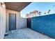 Private patio area featuring textured walls, gray brick pavers, and metal door at 7110 E Continental Dr # 1031, Scottsdale, AZ 85257