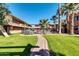 Community pool area featuring mature palm trees and manicured lawns at 7110 E Continental Dr # 1031, Scottsdale, AZ 85257