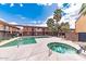 Community swimming pool featuring a jacuzzi and clear water, surrounded by apartment buildings at 7110 E Continental Dr # 1031, Scottsdale, AZ 85257