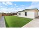 Backyard featuring artificial turf, stone pavers, and wood fencing at 739 E Glade Ave, Mesa, AZ 85204