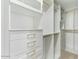 Custom closet with white shelving, drawers with gold pulls and ample storage space at 739 E Glade Ave, Mesa, AZ 85204