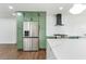 Charming kitchen featuring sage cabinetry, stainless appliances, and a lovely white subway tile backsplash at 739 E Glade Ave, Mesa, AZ 85204