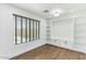 Bright, open-concept living room with wood floors and bright white built-in shelving at 739 E Glade Ave, Mesa, AZ 85204