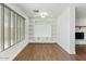 Bright, open-concept living room with wood floors, built-in shelving, and fireplace access at 739 E Glade Ave, Mesa, AZ 85204