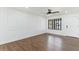 Well-lit living room with hardwood floors, decorative wall trim, and ceiling fan at 739 E Glade Ave, Mesa, AZ 85204