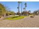 Backyard featuring an inground pool, an artificial turf lawn area, mature trees, and a pergola with seating at 8008 N 66Th St, Paradise Valley, AZ 85253