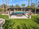 Lush backyard featuring a refreshing pool, comfortable outdoor seating under a shaded pergola and beautiful landscaping at 8008 N 66Th St, Paradise Valley, AZ 85253