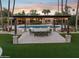 Lush backyard featuring a refreshing pool, comfortable outdoor seating under a shaded pergola and beautiful landscaping at 8008 N 66Th St, Paradise Valley, AZ 85253