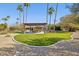 Expansive backyard features a covered patio, lush lawn, and desert landscaping at 8008 N 66Th St, Paradise Valley, AZ 85253