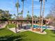 Beautiful backyard area with a pristine pool, covered pergola, and green artificial turf at 8008 N 66Th St, Paradise Valley, AZ 85253