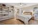 Bright bedroom with wood floors, a cozy bed, and ample shelving providing storage and character at 8008 N 66Th St, Paradise Valley, AZ 85253