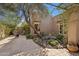 Private courtyard with stone tiling, mature trees, desert flora, and cozy seating at 8008 N 66Th St, Paradise Valley, AZ 85253