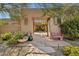 Inviting entrance featuring a covered walkway, desert landscaping, and a quaint pink bench at 8008 N 66Th St, Paradise Valley, AZ 85253