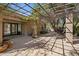 Charming covered patio with a tiled floor, potted plants, and a decorative trellis for outdoor relaxation at 8008 N 66Th St, Paradise Valley, AZ 85253