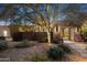 Landscaped exterior showcasing stone accents, desert plants, and a charming walkway leading to the home's entrance at 8008 N 66Th St, Paradise Valley, AZ 85253