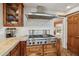 Spacious kitchen features a stainless steel stove, wooden cabinets and granite countertops at 8008 N 66Th St, Paradise Valley, AZ 85253