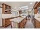 Modern kitchen with skylight, stainless steel appliances, an island, and wood cabinets at 8008 N 66Th St, Paradise Valley, AZ 85253