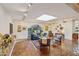 Spacious living room with Saltillo tile flooring, skylight, and arched window overlooking the yard at 8008 N 66Th St, Paradise Valley, AZ 85253