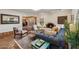 Cozy living room with Saltillo tile, fireplace and open to the dining area at 8008 N 66Th St, Paradise Valley, AZ 85253