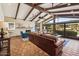 Bright living room with vaulted beamed ceilings, fireplace, and sliding doors to the backyard at 8008 N 66Th St, Paradise Valley, AZ 85253