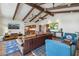 Bright living room with tile floors, beamed ceilings, a leather couch, and comfortable chairs at 8008 N 66Th St, Paradise Valley, AZ 85253