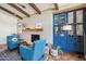 Cozy living room with terracotta tile, beamed ceilings, and built-in blue cabinets at 8008 N 66Th St, Paradise Valley, AZ 85253