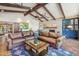 Spacious living room with Saltillo tile flooring, beamed ceiling, and fireplace at 8008 N 66Th St, Paradise Valley, AZ 85253