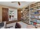 Spacious home office featuring built-in bookshelves and double doors leading to the living room at 8008 N 66Th St, Paradise Valley, AZ 85253