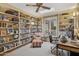 Home office features built-in bookshelves, a ceiling fan, a window and a skylight at 8008 N 66Th St, Paradise Valley, AZ 85253