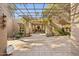 Stylish outdoor patio with a trellis covering, lush desert landscaping, and a serene ambiance at 8008 N 66Th St, Paradise Valley, AZ 85253