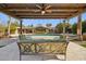 Covered patio featuring stylish seating, views of the backyard, and a cooling ceiling fan at 8008 N 66Th St, Paradise Valley, AZ 85253