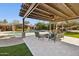 Inviting outdoor space features a pool, covered patio with seating, and lush green lawn at 8008 N 66Th St, Paradise Valley, AZ 85253