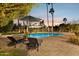 Inviting pool area with lounge chairs and umbrella, perfect for relaxation and enjoying the outdoors at 8008 N 66Th St, Paradise Valley, AZ 85253