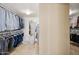 Spacious walk-in closet with built-in shelving and racks for organized storage at 8008 N 66Th St, Paradise Valley, AZ 85253