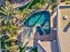 Aerial view of the pool featuring a spa, swim up bar, a pergola, and lush landscaping at 815 E County Down Dr, Chandler, AZ 85249