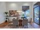 Bright dining room featuring a glass-top table, modern light fixture, and sliding doors to the outdoor patio at 815 E County Down Dr, Chandler, AZ 85249