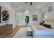 Well lit main bedroom with hardwood flooring and a view to the attached bathroom at 815 E County Down Dr, Chandler, AZ 85249