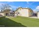 Spacious backyard featuring artificial grass, a detached garage, and seating area with a fire pit at 8215 E Cypress St, Scottsdale, AZ 85257