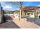 Backyard showcasing a hot tub, detached garage, covered patio, and xeriscaped area at 8215 E Cypress St, Scottsdale, AZ 85257