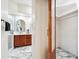 Bathroom showcasing marble flooring, a glass-enclosed shower, and a mirrored vanity at 8215 E Cypress St, Scottsdale, AZ 85257